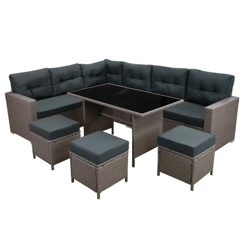 Elegantes Polyrattan Gartenmöbel Set in Grau mit bequemen, dunkelgrauen Polstern, bestehend aus einer L-förmigen Couch und einem Tisch mit Glasplatte