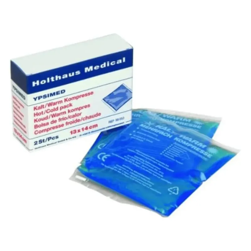 Abgebildet ist eine Schachtel mit der Aufschrift „Holthaus YPSIMED Kalt / Warm Kompresse 13 x 14 cm | Packung (2 Stück)“ von Holthaus Medical GmbH & Co. KG. Darin befinden sich zwei Kompressen, jede 13 x 14 cm groß und in durchsichtiges Plastik eingewickelt, das eine blaue Flüssigkeit enthält. Der Text auf der Schachtel ist mehrsprachig und hebt die Heiß- und Kaltanwendung des Produkts hervor, die in Erste-Hilfe-Situationen unerlässlich ist.